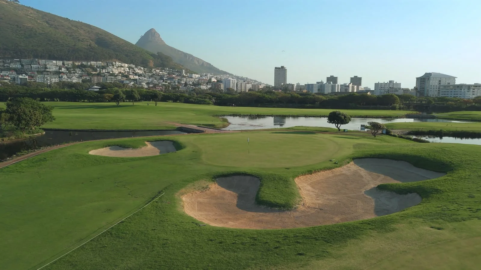 Bunkers around a green, with Lion's Head behind
